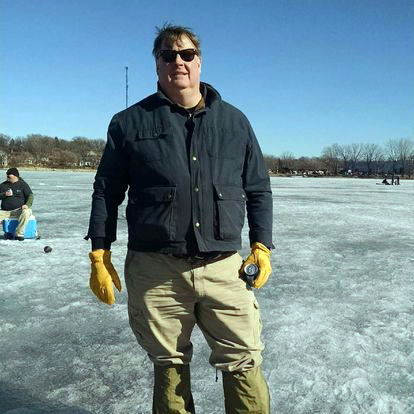 AIS Detector volunteer Brian Raney standing on an ice-covered lake.