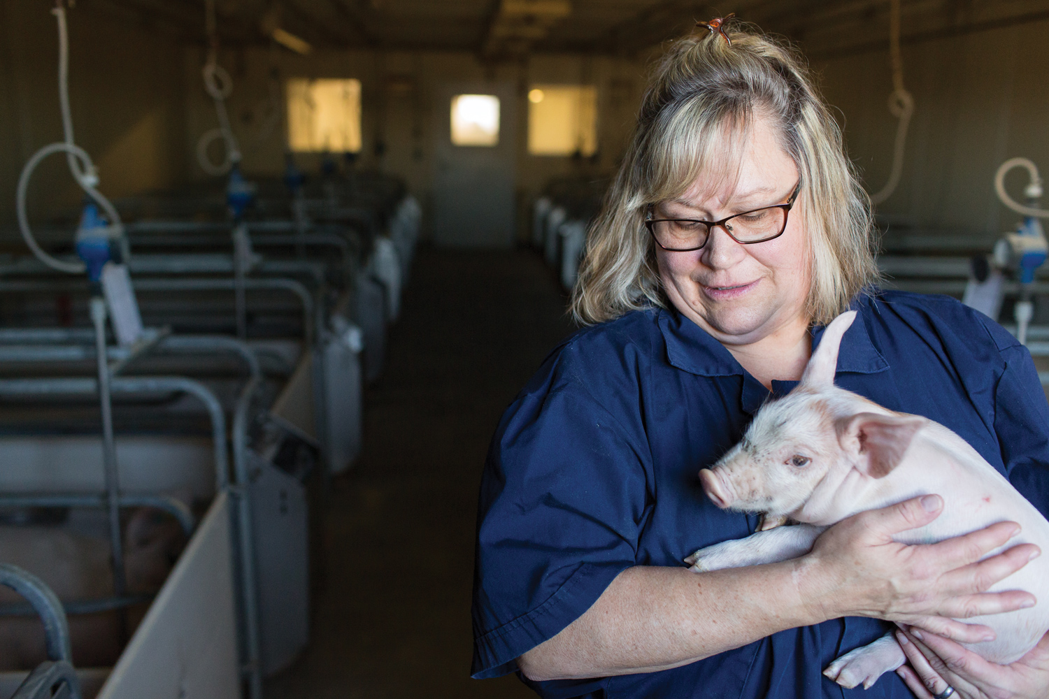 Diane DeWitte holding piglet