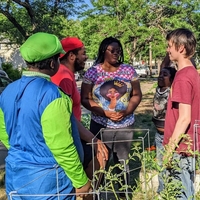 A group of UAI youth gathered outdoors on a sunny day