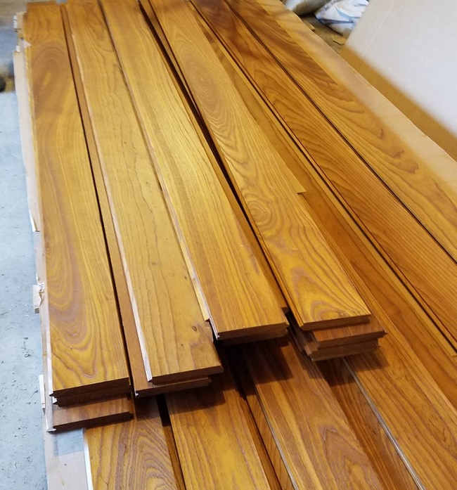 Stack of refinished tongue and groove Ash wood boards.