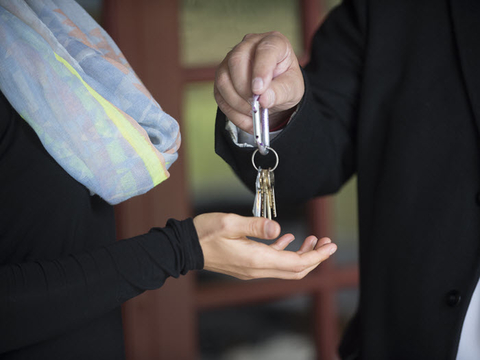  Keys being handed from a retiring business owner to the new owner.