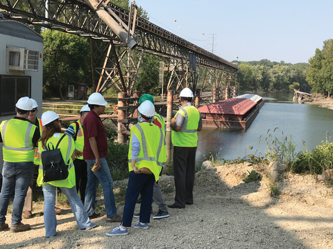 Group of people looking at barge on river