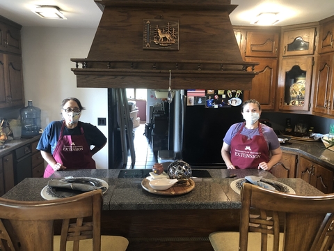 Health educators prepare for a virtual cooking class in a home kitchen