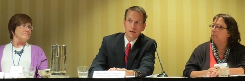 Peter Lindstrom sitting at a table with two other women as presenting panelists.