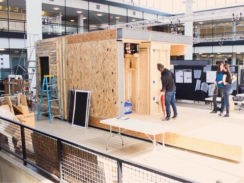 Start of the construction of the house in an indoor shop.