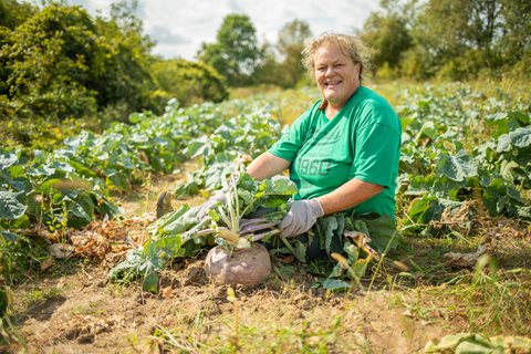 Farmer Rae Rusnak sitting in a field of turnips.