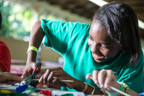 youth using a scissor for an art project