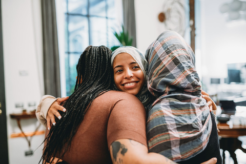 Three women hugging 