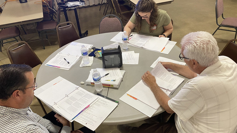 A group of three having a round-table discussion.