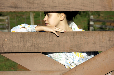 girl behind a fence