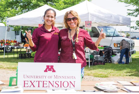 Extension SNAP-ed educators Thelma Garcia and Milena Nunez Garcia near a farmers market