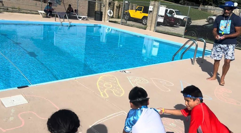 Youth gathered outside at a community pool