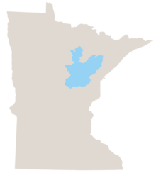 Map of Minnesota in gray with the north-central woodland area colored light blue.