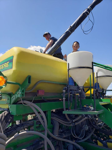 4-H'er Luke Gordon and his brother doing farm work