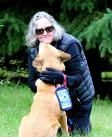 Kathleen Riley hugging a dog.