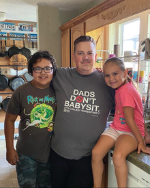 Father, son and daughter in their kitchen