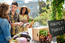 Farmers market seller and buyers