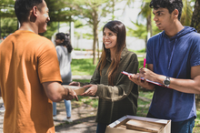 Three people chatting and smiling at one another