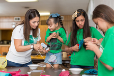 4-H'ers working on craft with leader