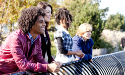 people leaning on a bench