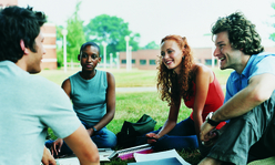 people talking in the grass in a circle