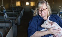 Educator holding piglet