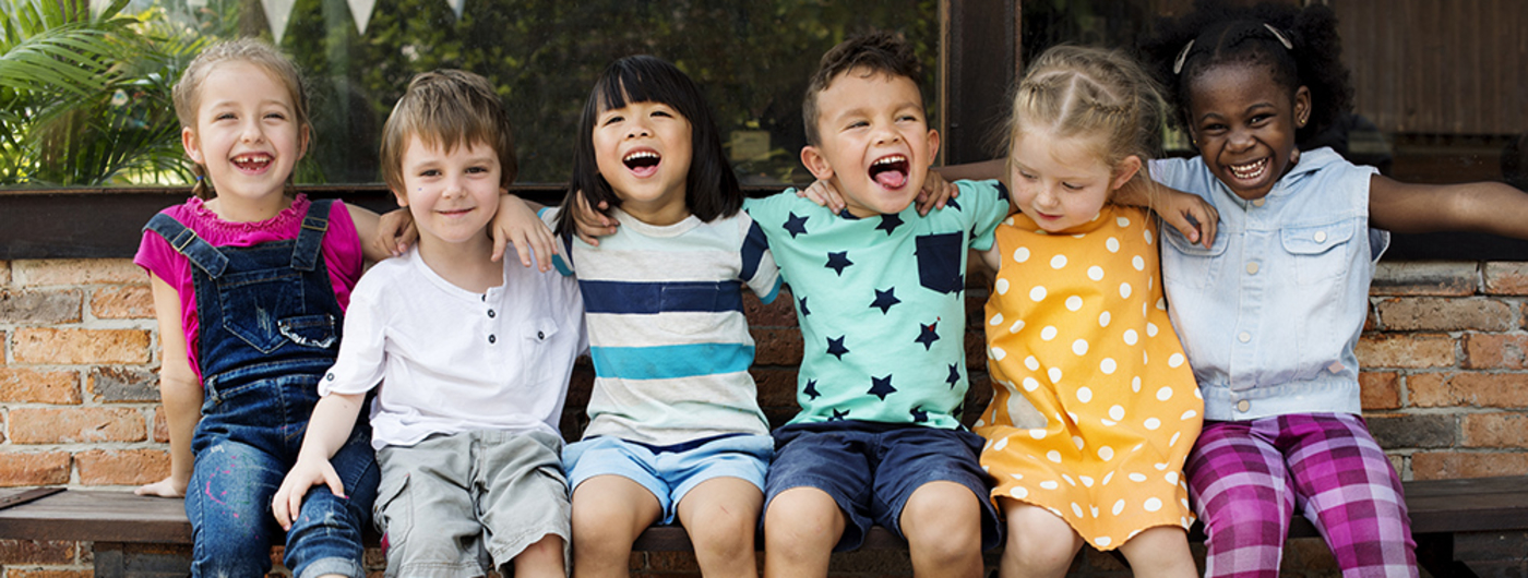 Young kids seated on bench