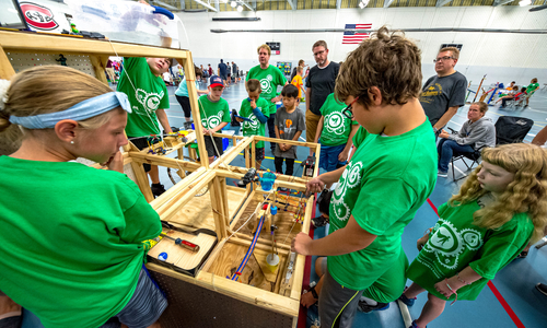 4-H kids working on a machine