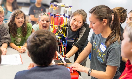 young teacher with kids and a lego model