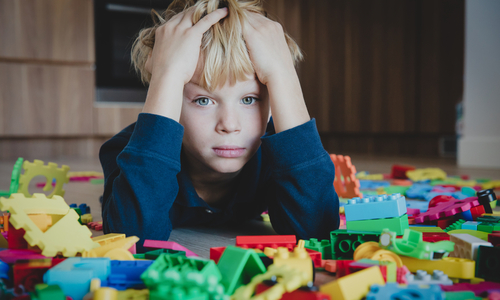 boy with hands on head