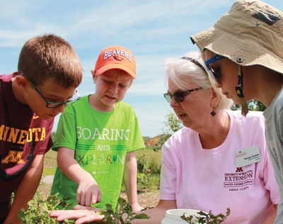 Master Gardener shows bug to children