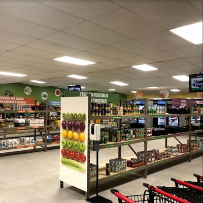 Food shelf looks more like a grocery store with good lighting, cleanliness, wide aisles, colorful signage and carts