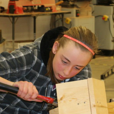 girl and boy building a birdhouse