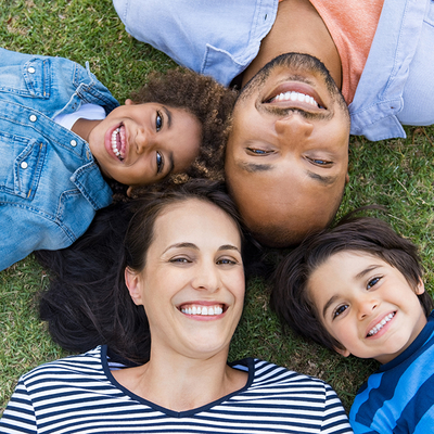 blended family with heads touching together