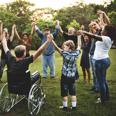 group of adults and youth holding hands in a circle