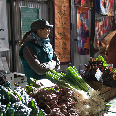 Woman selling vegetables at a farmer's market