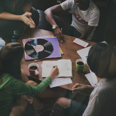 kids sitting around a table talking and writing