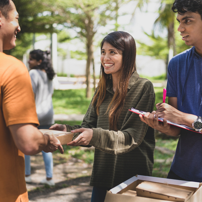 Three people chatting and smiling at one another