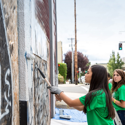 youth painting a building