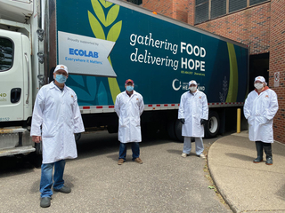 Masked workers by Second Harvest food truck