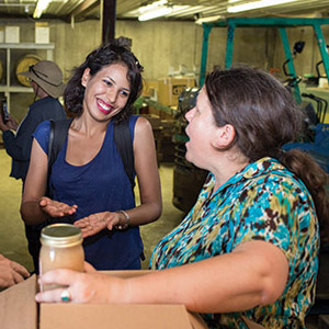 Two women talking in warehouse