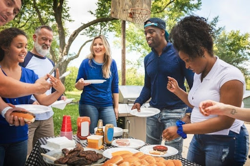 People eating at an outdoor buffet.